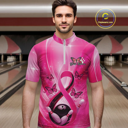 Male model wearing a bowling quarter-zip at the bowling lane displaying pink ribbon, butterfly, and bowling-themed graphics.