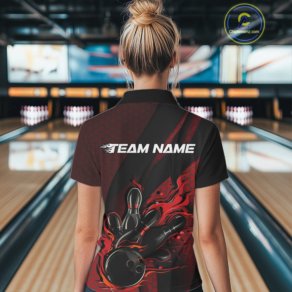 Female model at a bowling lane, back view of black and red quarter zip shirt featuring fiery bowling ball striking pins with hexagon and stripe design