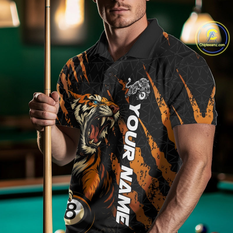 Front view male model wearing a polo shirt with a roaring tiger gripping billiard balls through orange claw marks.