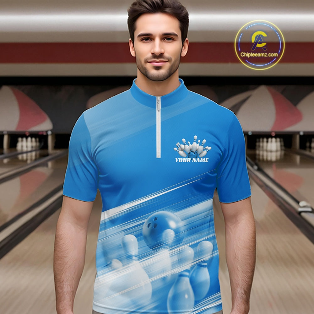 Front view male model at the bowling lane wearing a blue quarter zip shirt with bowling ball and pins over a pink geometric pattern.