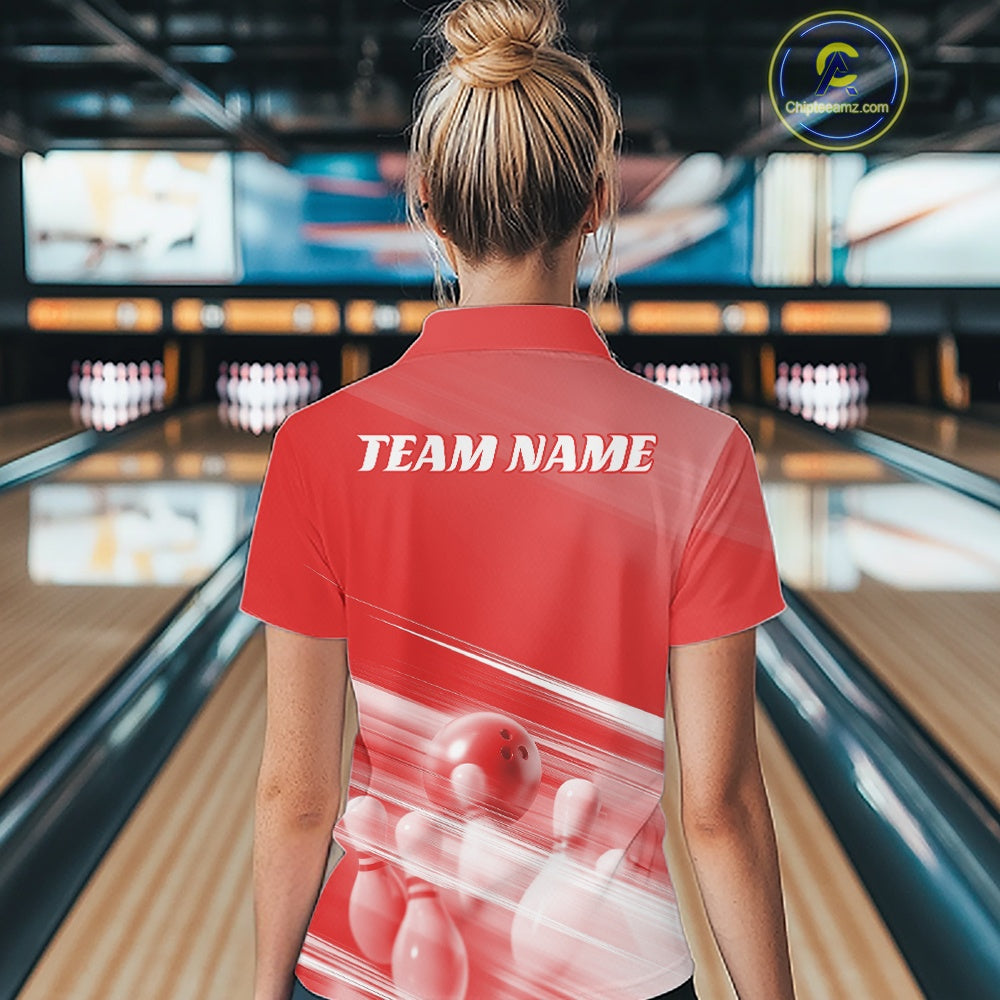 Back view of a female model in a bowling lane wearing a red quarter zip shirt with bowling ball and pins over a pink geometric background.