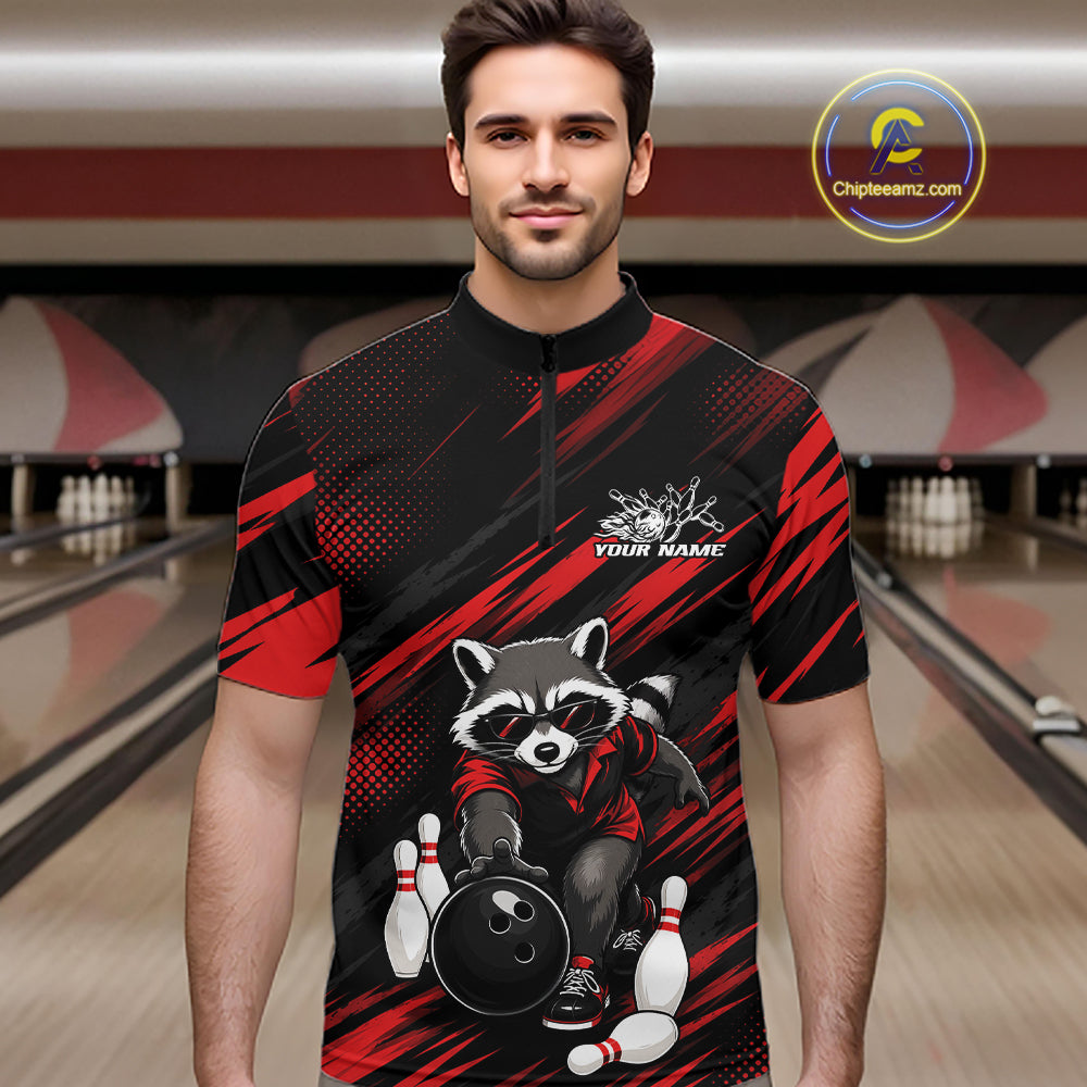 A man wearing a short-sleeve bowling jersey quarter zip shirt with a black and red graphic design featuring a raccoon holding a bowling ball. The jersey has a mock neck and a half-zip collar, with 'YOUR NAME' printed on the chest.