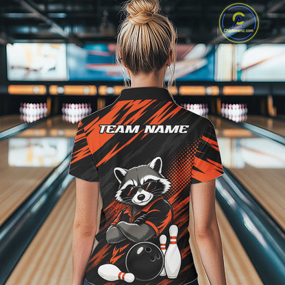A woman viewed from behind wearing a bowling-themed short-sleeve quarter zip shirt with a raccoon graphic and 'TEAM NAME' text, standing in a bowling alley.