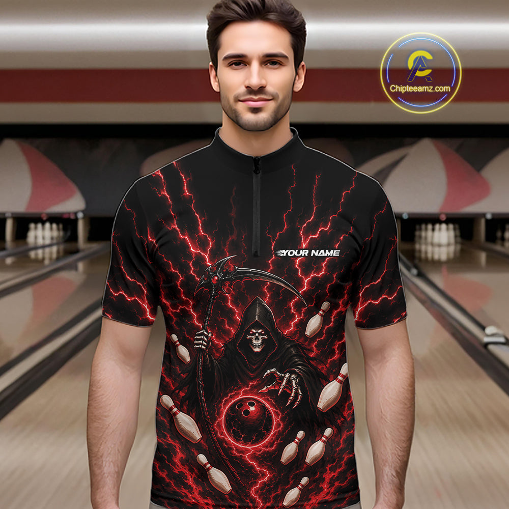 A man wearing a black short-sleeve zip-up shirt with a grim reaper graphic, red lightning, bowling pins, and a bowling ball, set against a blurred bowling alley background.