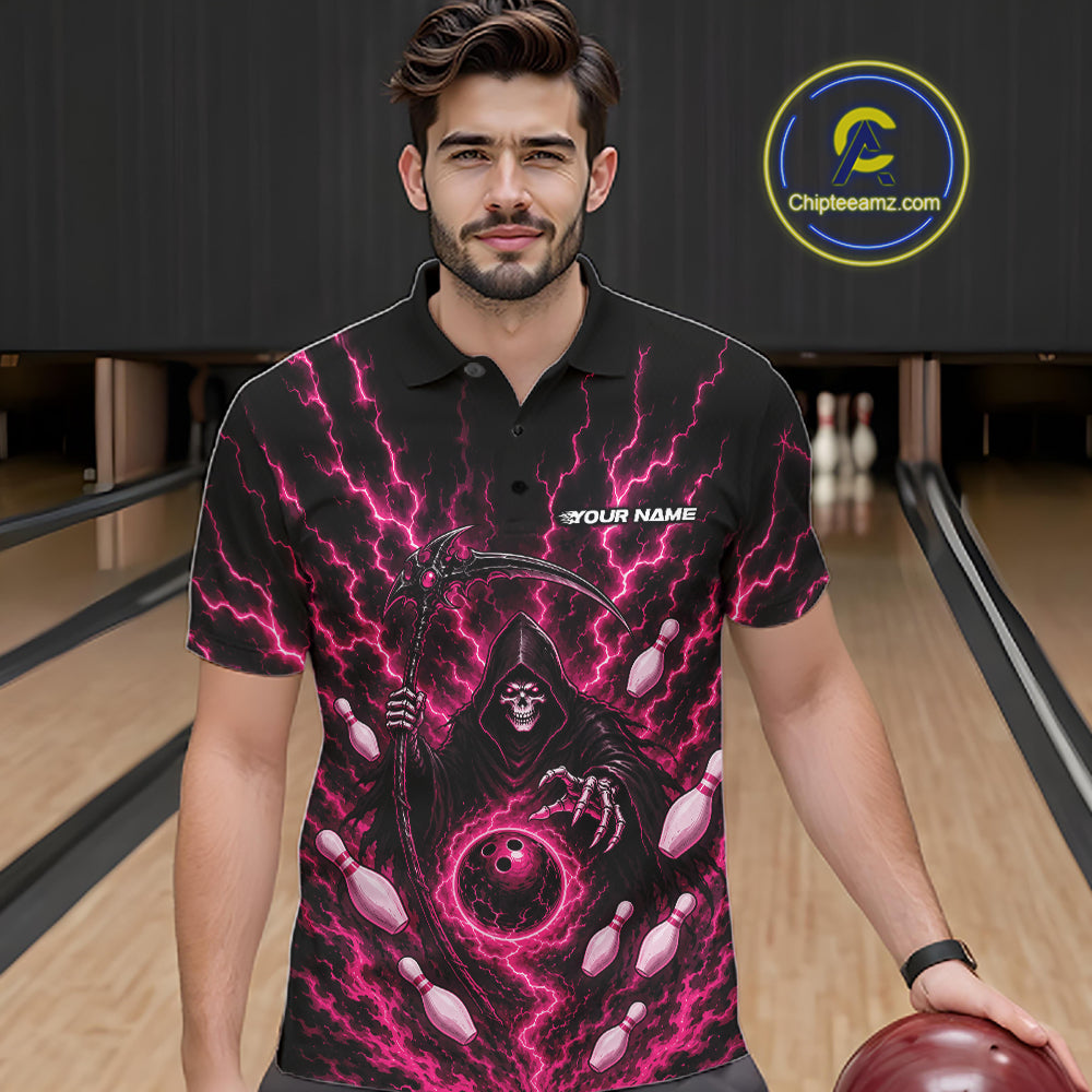 A man wearing a black short-sleeve polo shirt with a vivid pink and purple grim reaper graphic, standing in a bowling alley holding a bowling ball.