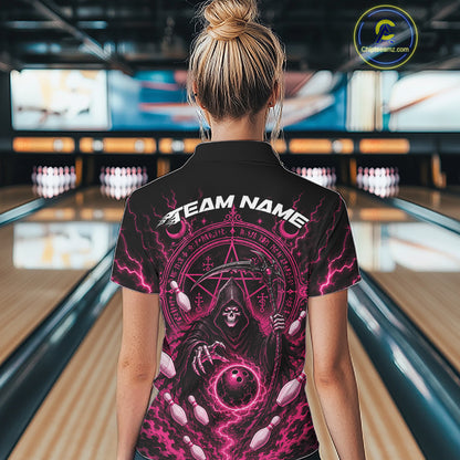 A woman viewed from behind wearing a black short-sleeve bowling shirt with a large pink and white grim reaper graphic and the text 'TEAM NAME' on the back, standing in a bowling alley.