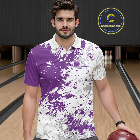 Front view of a male model in a bowling lane wearing a purple and white splatter polo shirt with clean sporty bowling graphics.