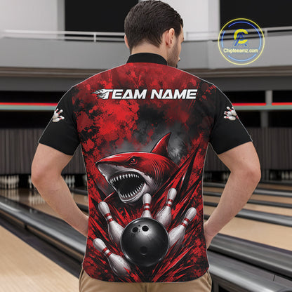 Person wearing a red and black bowling shirt with a shark design on a bowling alley.