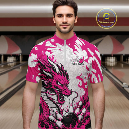 Man wearing a pink and white bowling shirt with a dragon design in a bowling alley.
