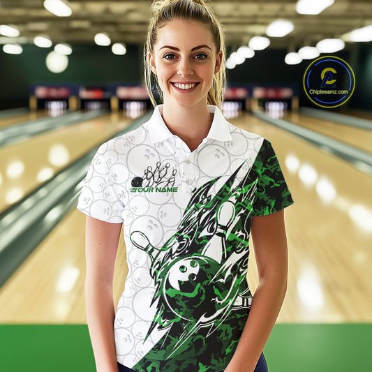 Female model wearing a white bowling polo shirt at the lane with green camo-inspired bowling graphics and subtle ball details.