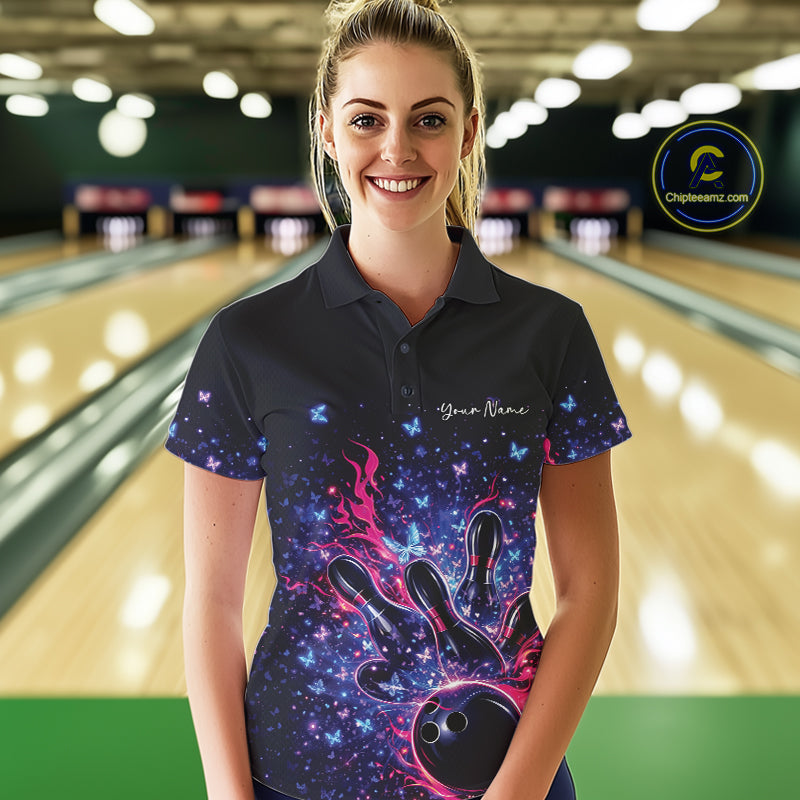Female model wearing a colorful bowling polo shirt at the lane with flames, bowling pins, and butterfly graphics.