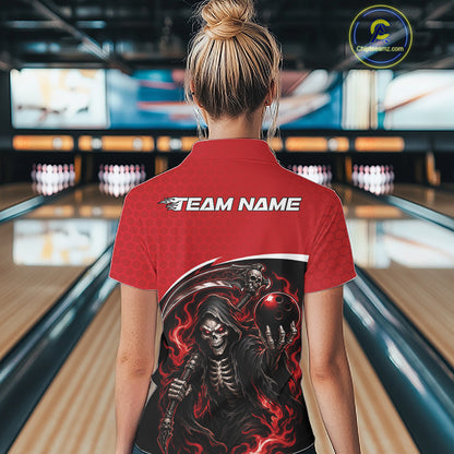 A woman viewed from behind wearing a red short-sleeve bowling shirt with a large black and red grim reaper graphic on the back and 'TEAM NAME' printed in white across the shoulders. The background shows a blurred bowling alley with lanes and pins.