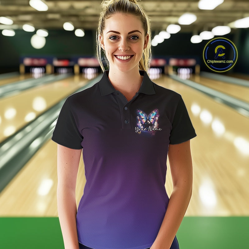Female model wearing a colorful bowling polo shirt at a bowling lane with glowing butterfly artwork, a bowling ball, and fallen bowling pins.