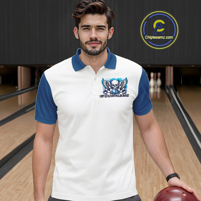 Front view of a male model in a bowling alley wearing a bowling polo shirt featuring a gothic skull with wings, bowling ball, pins, and ornamental swirls with a personalized name on a white and blue design.
