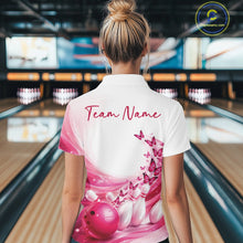 Load image into Gallery viewer, Female model wearing a white and pink bowling polo with butterfly artwork and bowling graphics, back view inside a bowling center