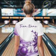 Load image into Gallery viewer, Female model wearing a white and purple bowling polo with butterfly artwork and bowling graphics, back view at the bowling lane