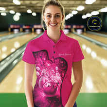 Load image into Gallery viewer, Female model wearing a pink bowling polo with butterfly artwork and bowling graphics, front view at the bowling lane