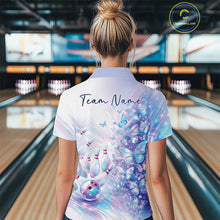 Load image into Gallery viewer, Back view of a female model wearing a bowling polo decorated with pastel purple and pink holographic butterflies and bowling graphics