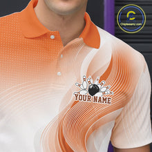 Load image into Gallery viewer, Detailed left chest view of a white and orange bowling polo shirt with abstract line motifs and a bowling ball hitting the pins