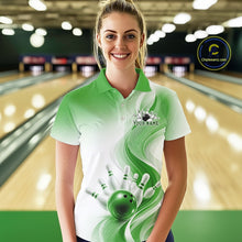 Load image into Gallery viewer, Female model wearing a white and green bowling polo with flowing abstract wave graphics and a glossy bowling ball striking pins, front view at the bowling lane