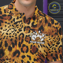 Load image into Gallery viewer, Close-up of a yellow, brown, and black leopard-print bowling shirt with a chest graphic showing pins, a patterned bowling ball, and “Your Name.”