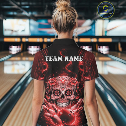 Back view of a female model in a bowling venue wearing a black and red quarter-zip shirt featuring a Day of the Dead bowling design.