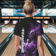 Load image into Gallery viewer, Back view of a female model in a bowling alley wearing a black bowling polo with a purple flaming skull, lightning, bowling pins, and a custom name.
