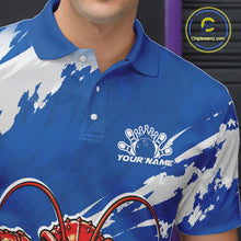 Load image into Gallery viewer, Close up front view of the left chest area on a blue custom bowling polo shirt featuring a fierce yet funny crawfish bowling character and a distressed background design.