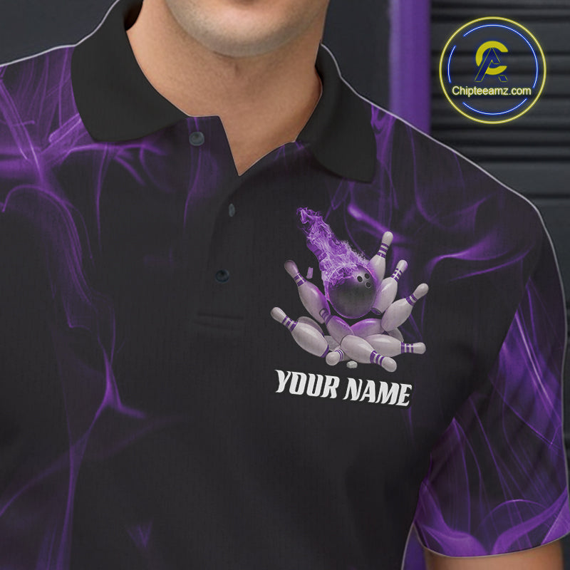Close-up of a black and purple bowling polo shirt left chest showcasing a bowling ball crashing into pins with flame effects.
