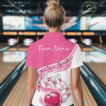 Load image into Gallery viewer, Female model wearing a white and pink bowling polo with butterfly graphics and bowling artwork, back view at the bowling lane