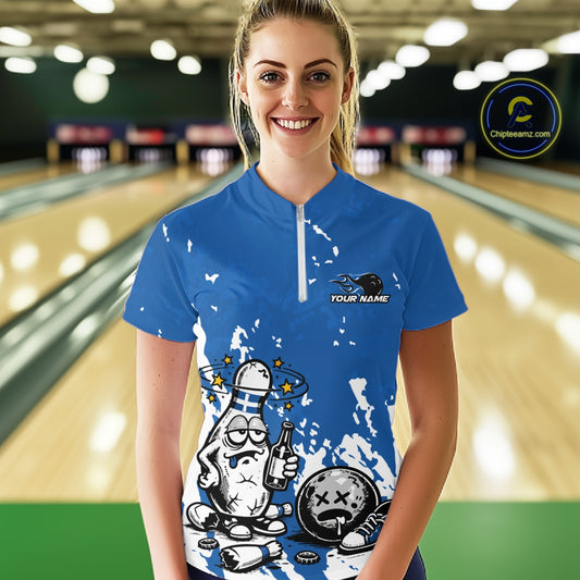 Front view female model in blue and white quarter zip bowling shirt in bowling lane, playful beer themed bowling pin illustration