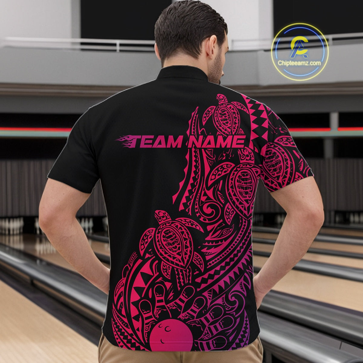 Front view of a male model in a black, pink, and purple bowling quarter-zip shirt showcasing tribal swirl accents and turtle motifs.