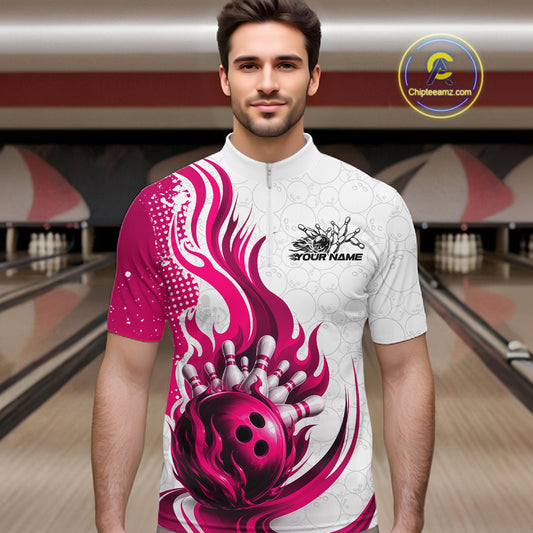 A man wearing a short-sleeve bowling-themed jersey with a red and white flame design and a bowling ball graphic, standing in front of a blurred bowling alley background.
