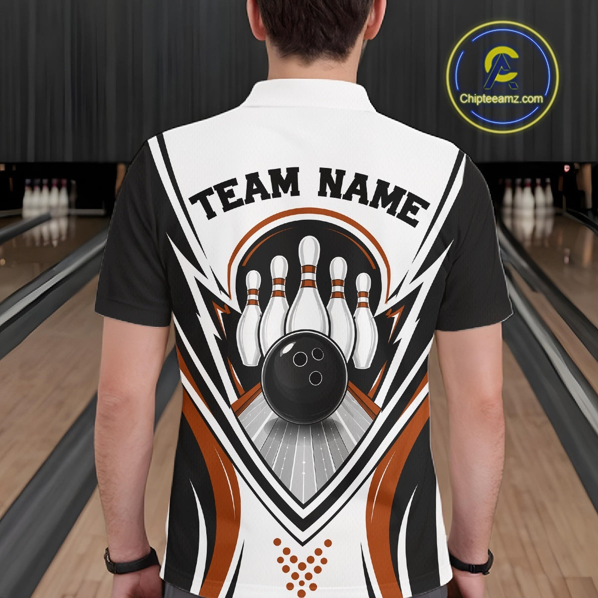 Back view of a male model wearing a white, black, and orange bowling polo shirt featuring bowling ball and pins graphics inside a bowling lane.