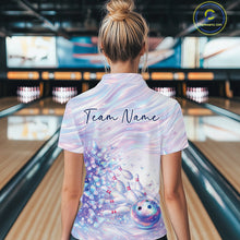 Load image into Gallery viewer, Back view of a female model wearing a bowling quarter zip with pastel purple and pink holographic butterflies and colorful bowling graphics in a bowling alley