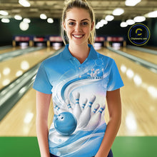 Load image into Gallery viewer, Female model standing in a bowling lane wearing a white and blue bowling polo shirt featuring abstract wave lines and a glossy bowling ball striking pins on the front.