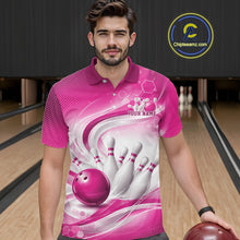 Load image into Gallery viewer, Male model standing in a bowling lane wearing a white and pink bowling polo shirt featuring abstract wave lines and a glossy bowling ball striking pins on the front.