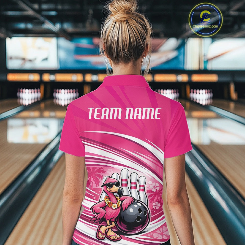Back view of a female model in a bowling center wearing a pink polo shirt showcasing a tropical flamingo and bowling ball artwork.