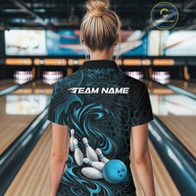 Load image into Gallery viewer, Back view of a female model wearing a black and blue bowling quarter-zip shirt in a bowling alley featuring a tribal flame bowling ball and pins graphic
