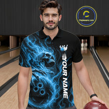Load image into Gallery viewer, Male model wearing a black bowling polo shirt in a bowling alley featuring a skull clutching a bowling ball surrounded by swirling blue energy flames