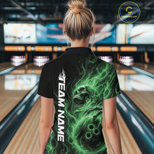 Load image into Gallery viewer, Back view of a female bowler wearing a black bowling quarter-zip shirt featuring a green flaming skull holding a bowling ball surrounded by swirling energy flames