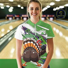 Load image into Gallery viewer, Front view of a happy female model in a bowling alley wearing a green custom quarter zip bowling shirt with a funny graffiti turkey holding a bowling ball, paint splatter accents, and a personalized name.