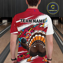 Load image into Gallery viewer, Back view of a male model wearing a red custom bowling polo shirt with a funny graffiti turkey holding a bowling ball, paint splatter accents, and a personalized name in a bowling alley.