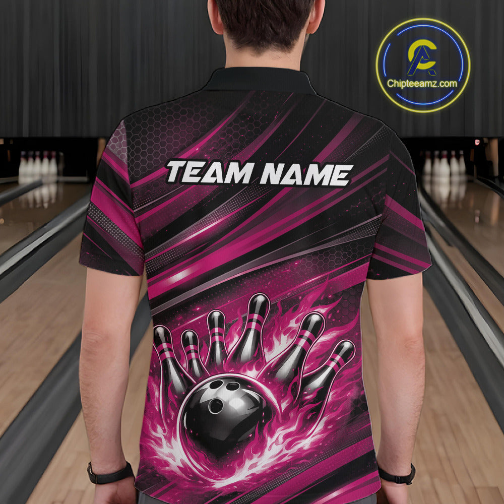 Back view of a male model in a bowling venue wearing a black and pink polo shirt featuring a flaming bowling ball hitting the pins.