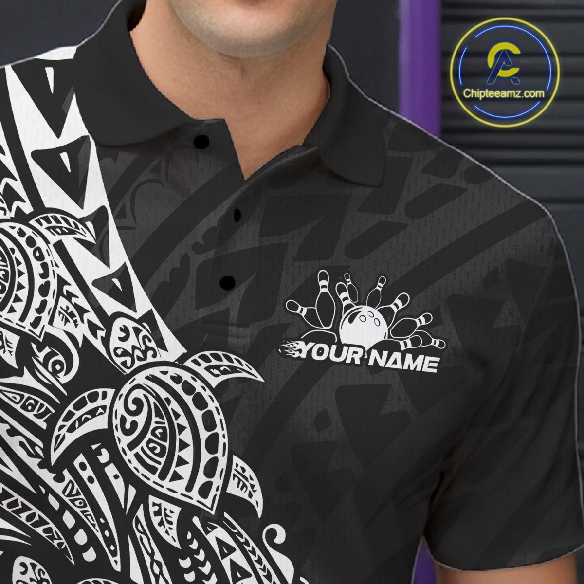 Close-up of the left chest on a black and white bowling polo shirt displaying Polynesian-inspired bowling motifs.