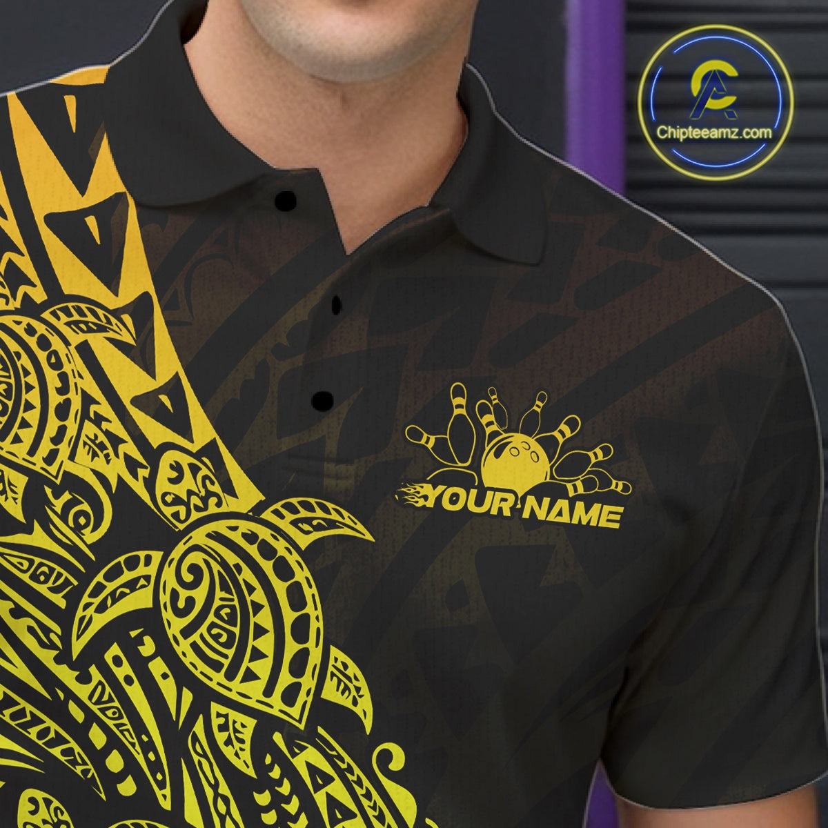 Left chest close-up of a black and gold bowling polo shirt featuring bowling graphics accented by tribal turtle patterns.