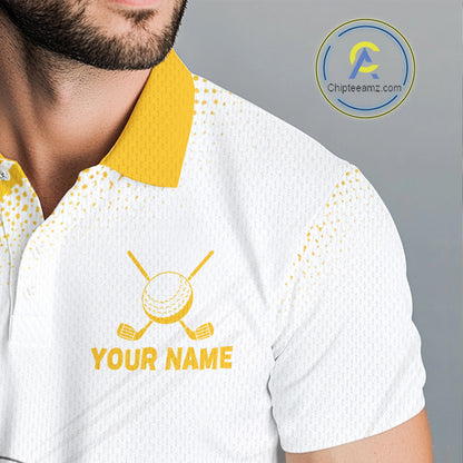 A close-up of a man wearing a white short-sleeve polo shirt with a yellow collar and yellow printed golf-themed graphic on the chest, including crossed clubs, a golf ball, and the text 'YOUR NAME'.