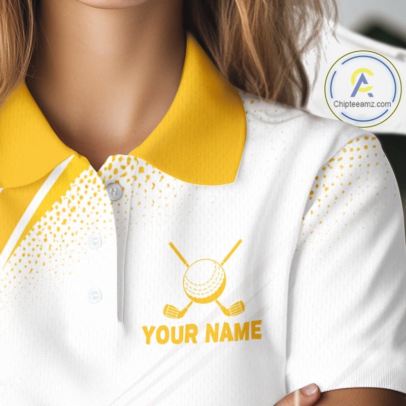 A close-up of a white polo shirt with a yellow collar and yellow printed golf-themed graphic and text reading 'YOUR NAME' on the chest, worn by a person. A circular 'Chipteamz.