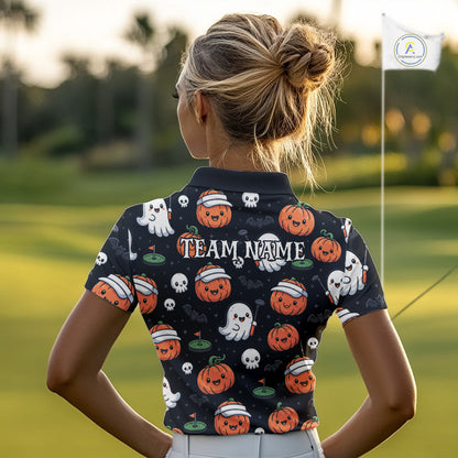 A woman viewed from behind on a golf course, wearing a short-sleeve dark polo shirt with a Halloween print of pumpkins, ghosts, skulls, and the text 'TEAM NAME' across the back.