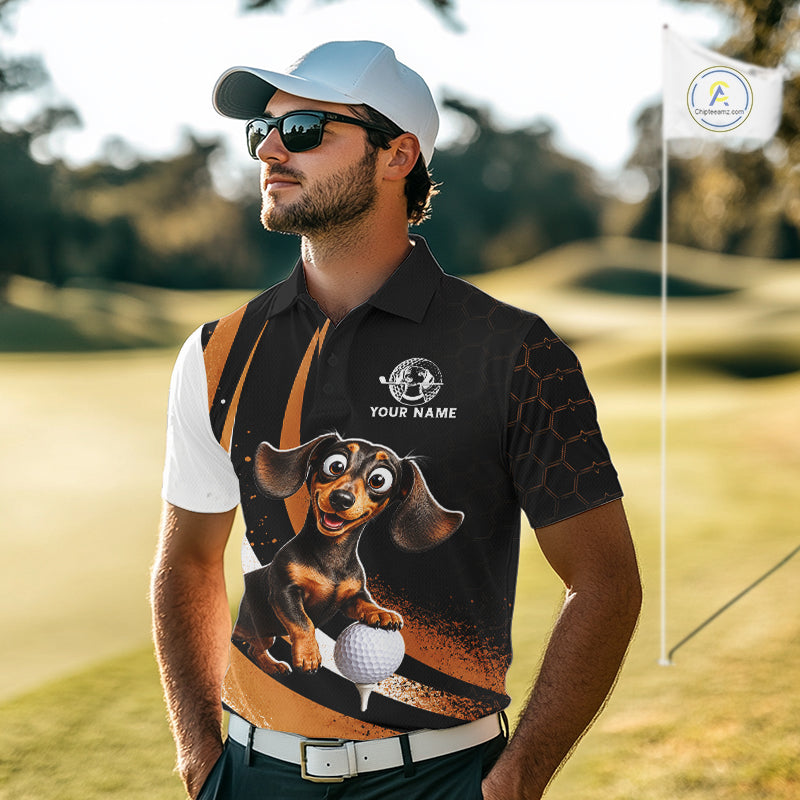 A man wearing a custom black and white golf polo shirt with a cartoon dachshund graphic and a white cap, standing on a golf course.